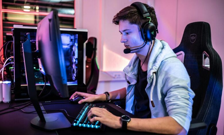 a man wearing a headset and using a computer